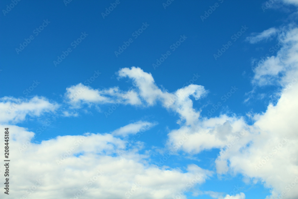 Beautiful natural blue sky and white fluffy clouds. Background. Landscape. Beautiful natural blue sky and white fluffy clouds. Background. Landscape.