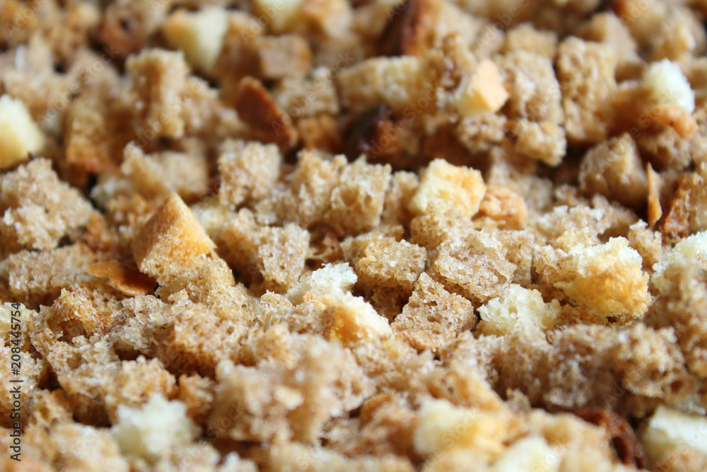 Finely chopped rusks. Dried bread diced. Close-up. Background. Finely chopped rusks. Dried bread diced. Close-up. Background.