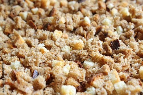 Finely chopped rusks. Dried bread diced. Close-up. Background.
