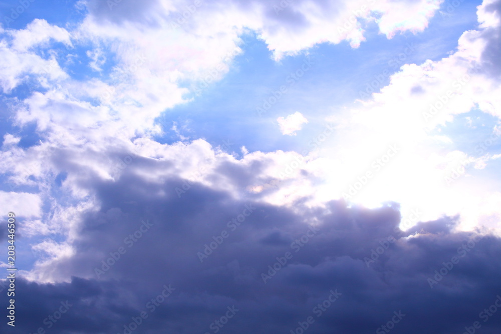 Obraz premium A beautiful cloudy sky, cumulus clouds and scorching sun. Background. Landscape.
