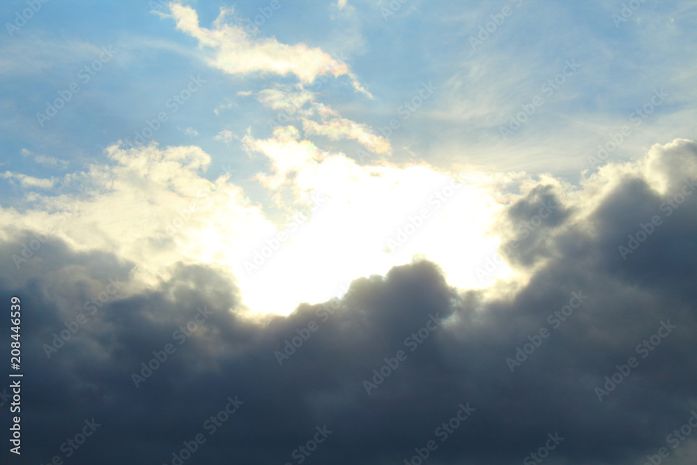 A beautiful cloudy sky, cumulus clouds and scorching sun. Background. Landscape.