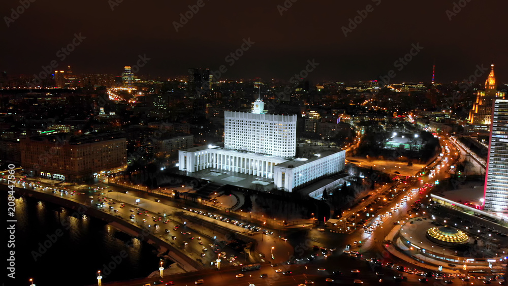 The White House of Russia surrounded by wide streets. Intensive traffic of the city. City panorama with night illumination.
