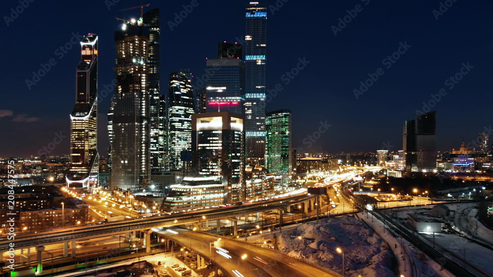 Moscow-city night life Beautiful shot. City traffic and night illumination. Skyscrapers with illuminated windows in the middle of traffic junction.