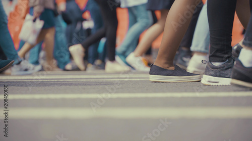 People pedestrians walks across a busy city street