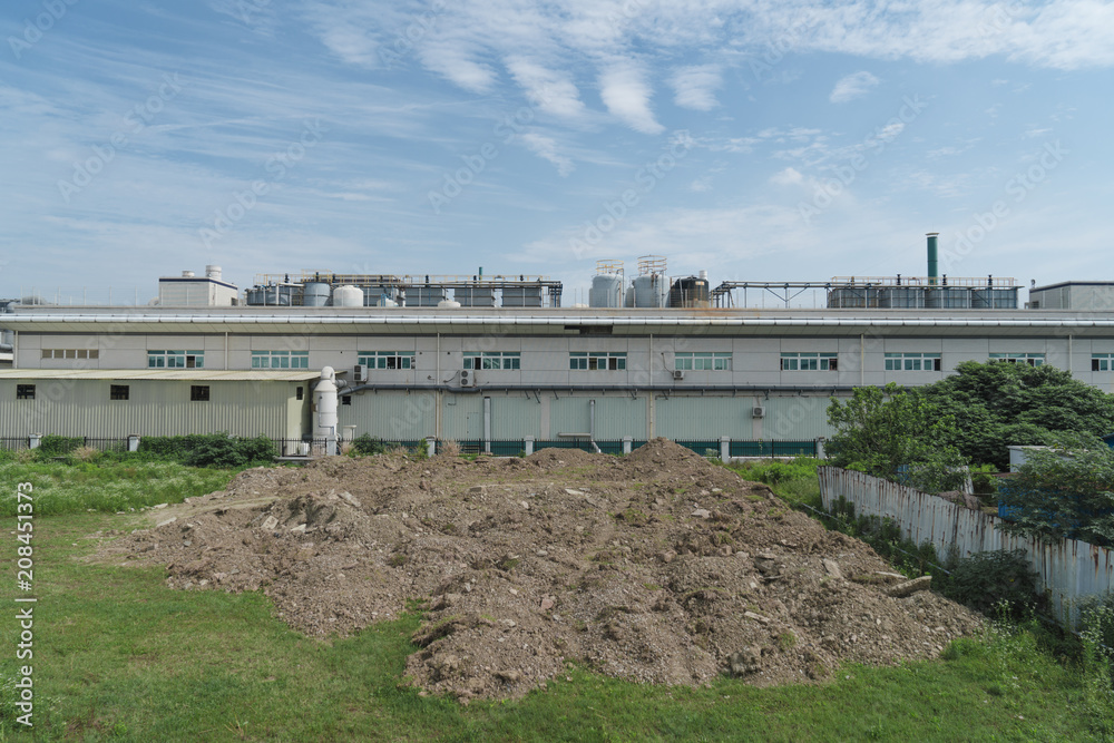 Factory building in the suburbs, industrial plant background Factory building in the suburbs, industrial plant background