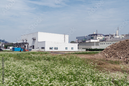 Factory building in the suburbs, industrial plant background