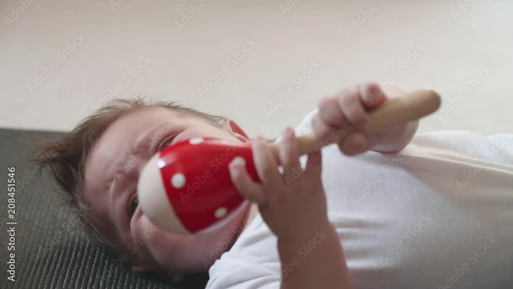 Cute Infant Baby Boy Gets Irritated and Starts Crying - Hits Himself Accidentally With Rattle Toy Cute Infant Baby Boy Gets Irritated and Starts Crying - Hits Himself Accidentally With Rattle Toy