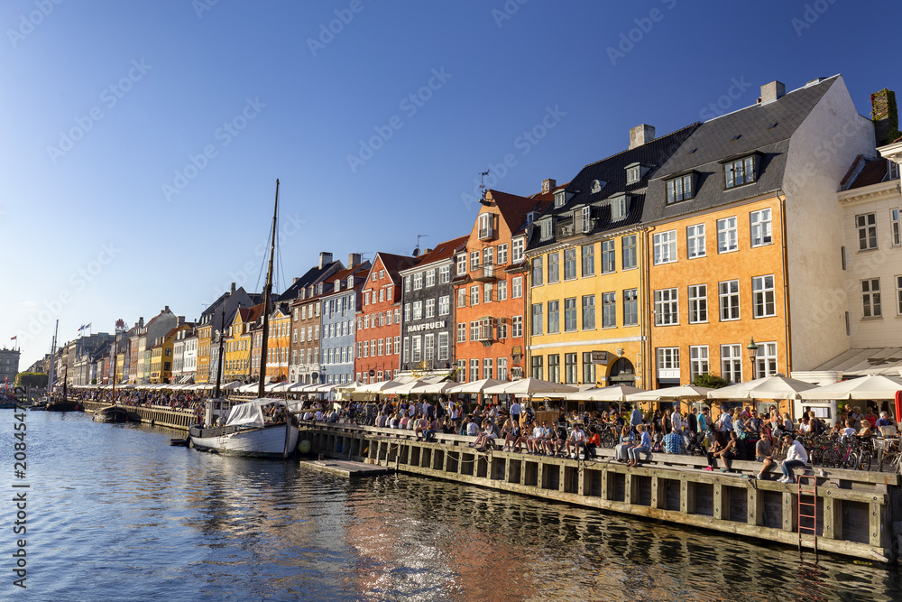 COPENHAGEN, DENMARK - AUGUST 26: Unidentified pedestrians walk past beautiful buildings in Copenhagen, Denmark on August 26, 2016.