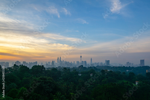 Canvas Print Cloudy sunrise over KL Tower and surrounded buildings in downtown Kuala Lumpur, Malaysia