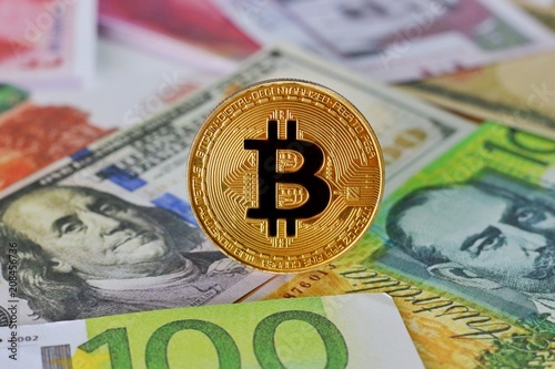 Golden Bitcoin on International banknotes background, Exchange Currency concept