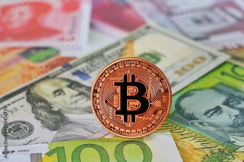 Golden Bitcoin on International banknotes background, Exchange Currency concept