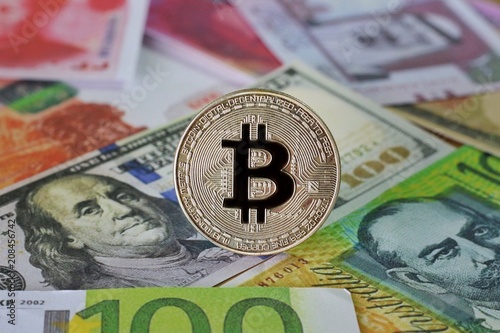 Golden Bitcoin on International banknotes background, Exchange Currency concept