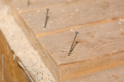 Screws in the boards. Screws in the board on the floor.