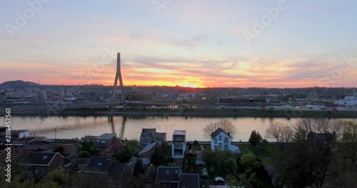 Aerial view of steel cable bridge crossing in Belgium. Road in perspective. European bridge over a river at sunset. photo