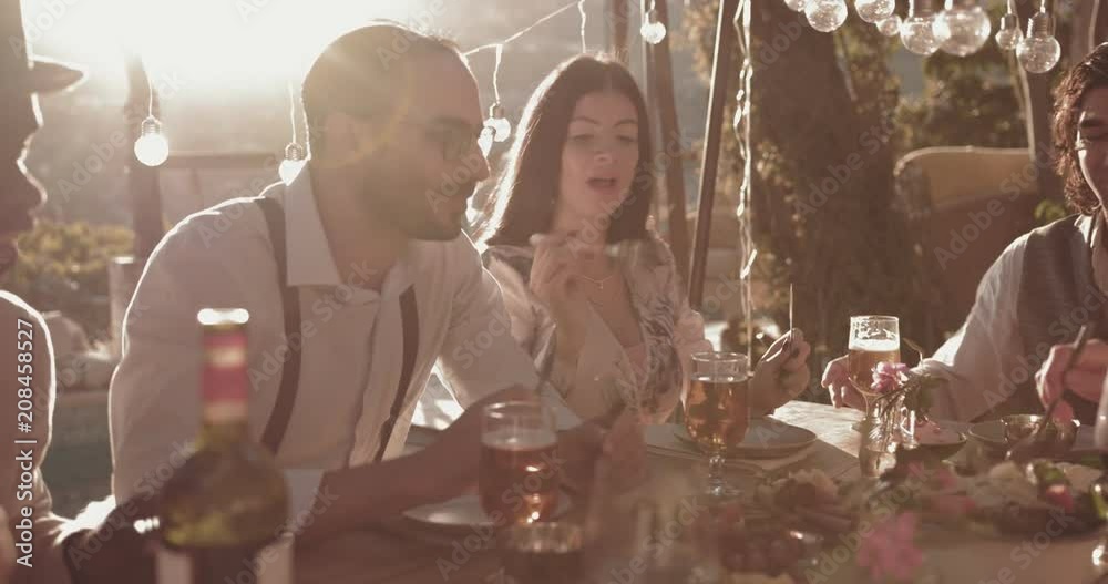 Friends and couples eating mediterranean lunch at rustic mountain cottage