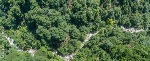Forest river flowing between two high rocks with green plants in Georgia. Okatse canyon