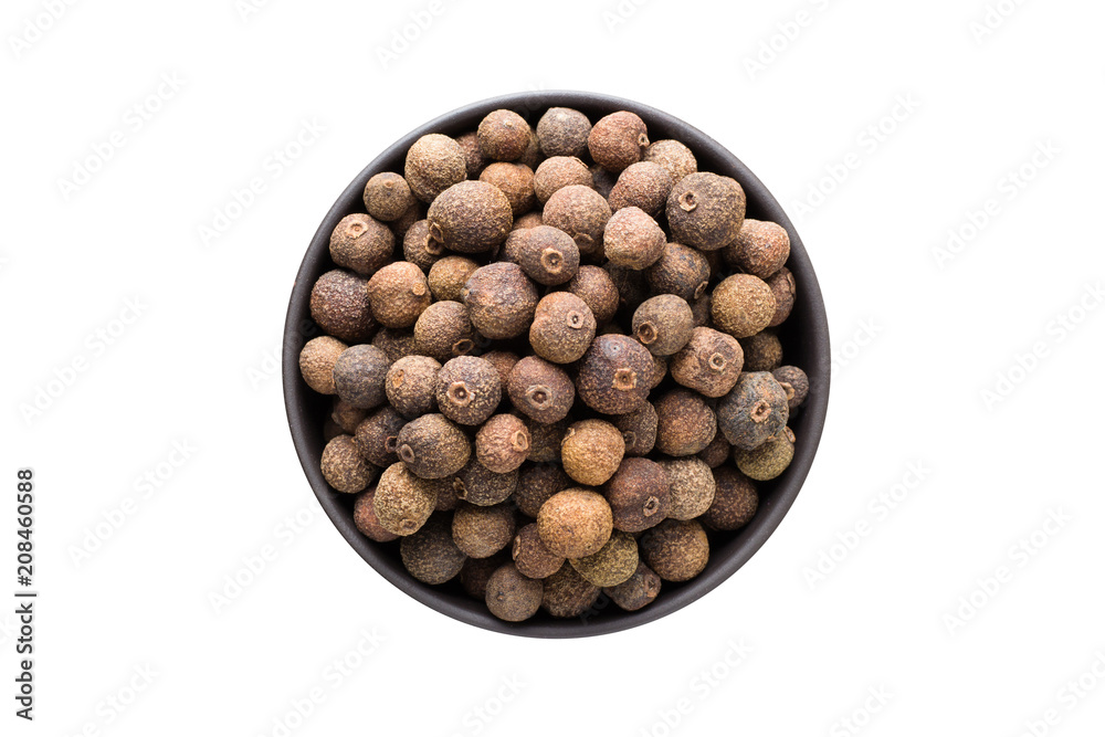 allspice pepper in clay bowl isolated on white background. Seasoning or spice top view - obrazy, fototapety, plakaty 