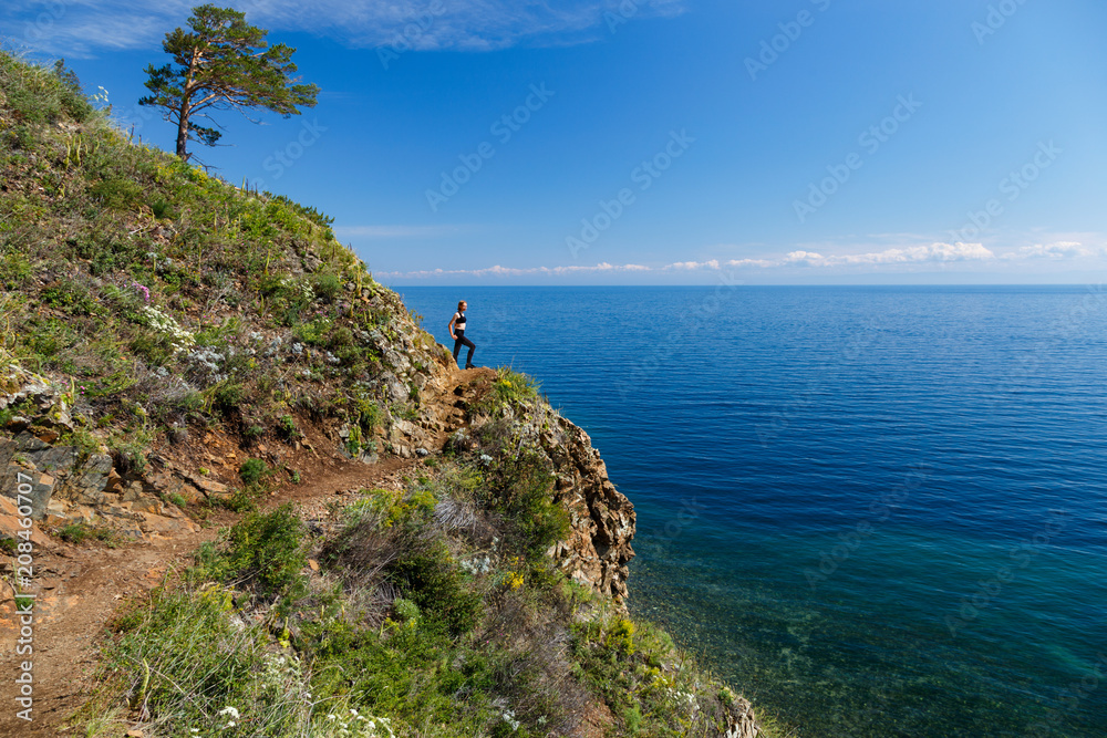 View of Baikal lake with a girl and a tree