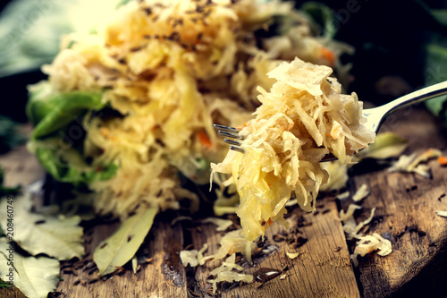 Sauerkraut on a fork with a shallow depth of field. Pickling cabbage at home. The best natural probiotic.