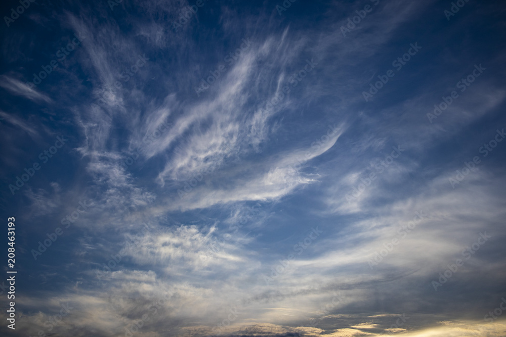 Blue dark sky with windy clouds on an abstract background Blue dark sky with windy clouds on an abstract background
