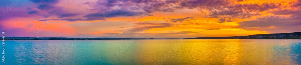 Sunset over the lake. Amazing panorama landscape