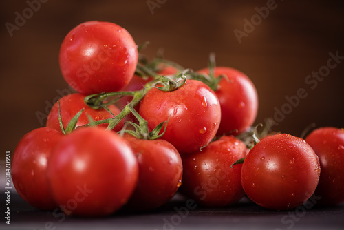 close up of fresh washed tomatoes on vine