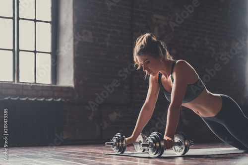 Sporty girl with dumbbells