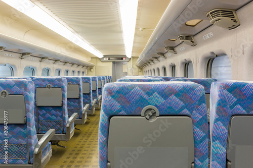 Interior of electric train with empty seats business transportation background.