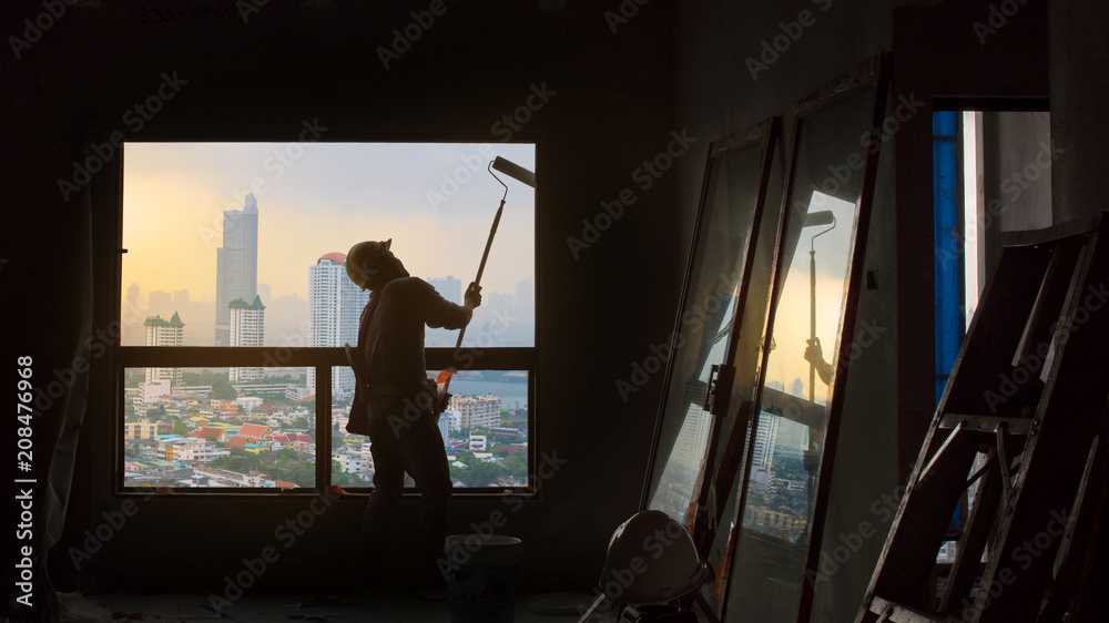 silhouettes painter looking to sky from high building silhouettes painter looking to sky from high building