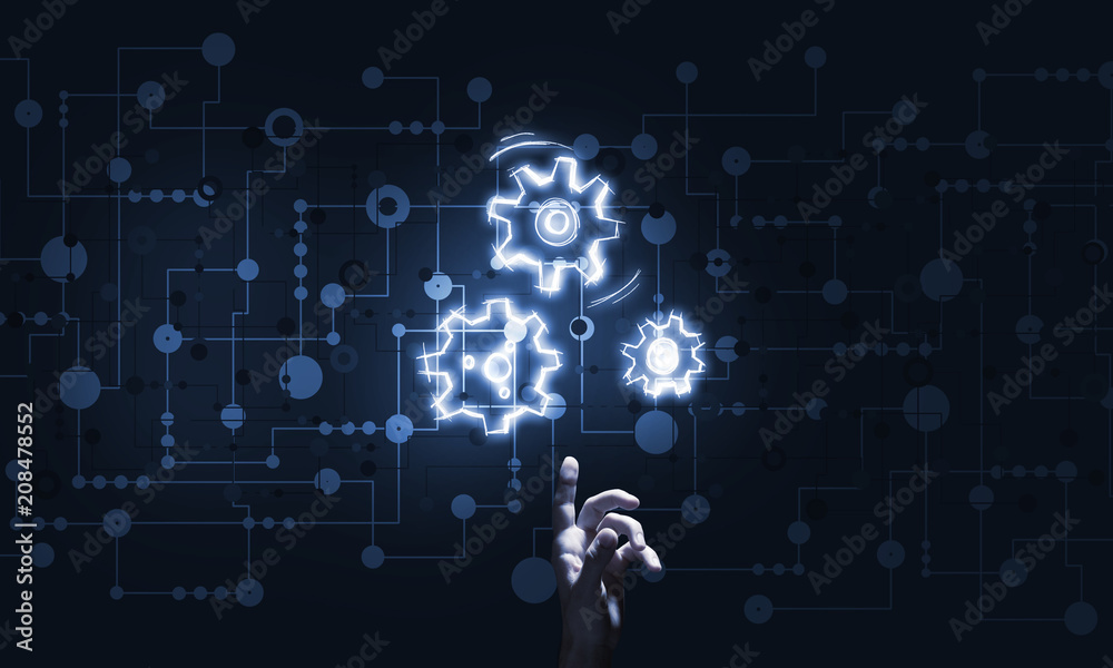 Glowing cogwheel mechanism icon on dark background as symbol of teamwork Glowing cogwheel mechanism icon on dark background as symbol of teamwork