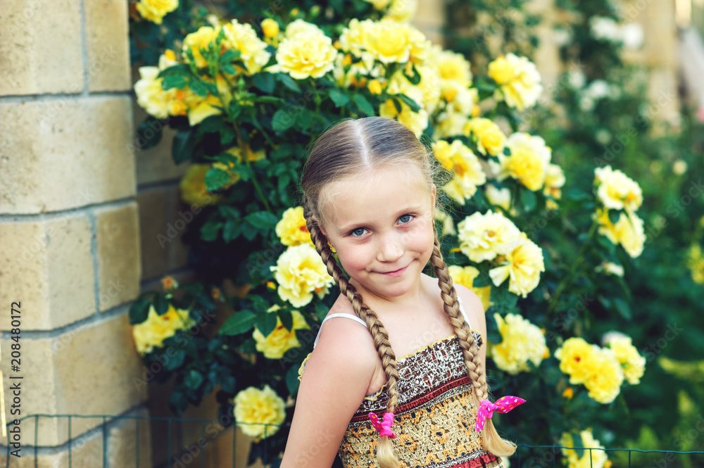 Portrait of a girl with braids on a background of roses Portrait of a girl with braids on a background of roses