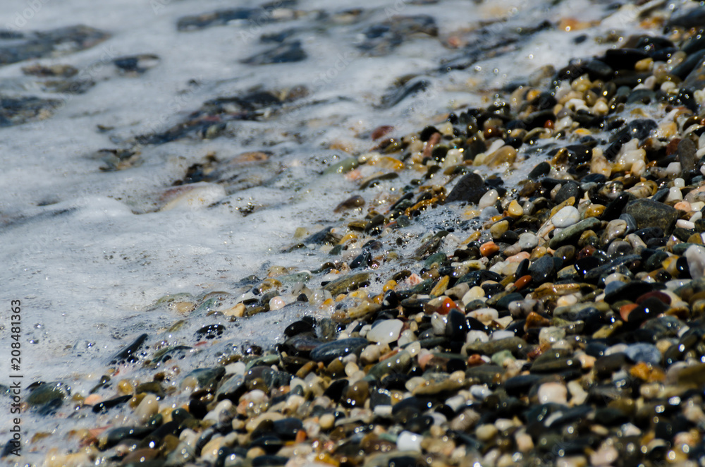 pebble beach washed by sea waves, small and various stones forming the shore pebble beach washed by sea waves, small and various stones forming the shore