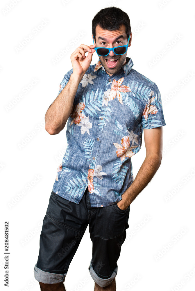Handsome man with flower shirt with sunglasses on isolated white background Handsome man with flower shirt with sunglasses on isolated white background