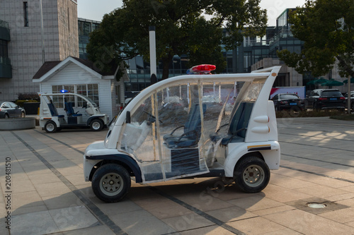 Small white electric police car, patrol buggy in the park