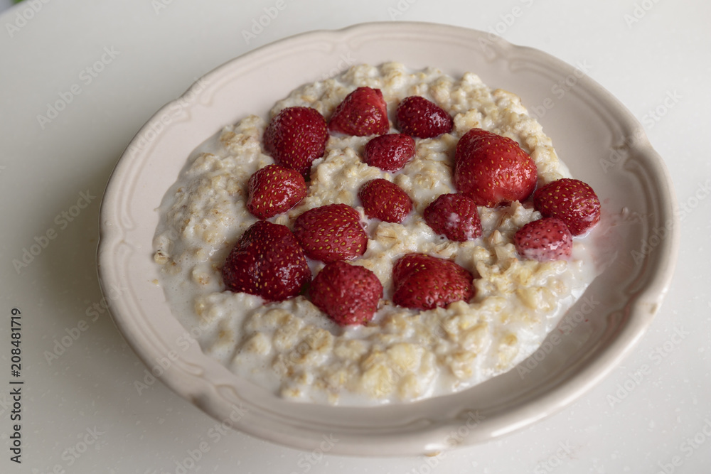 Oatmeal porridge on milk with strawberries. Perfect as a healthy breakfast. Oatmeal porridge on milk with strawberries. Perfect as a healthy breakfast.