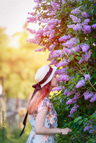Beautiful girl at the lilac Bush-summer  spring and the concept of lifestyle