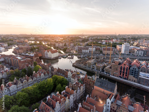 Photo of the old town of Gdansk architecture in sunset light. Aerial shot. Channel and buildings - top view