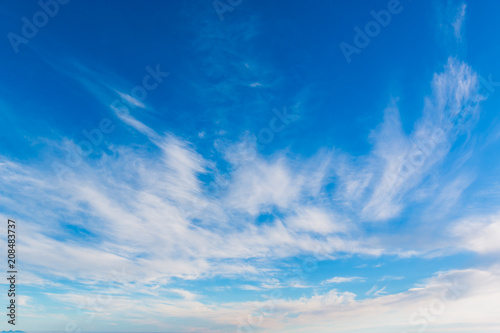 Bright sky blue background. Sky in daylight with beautiful white cloud.