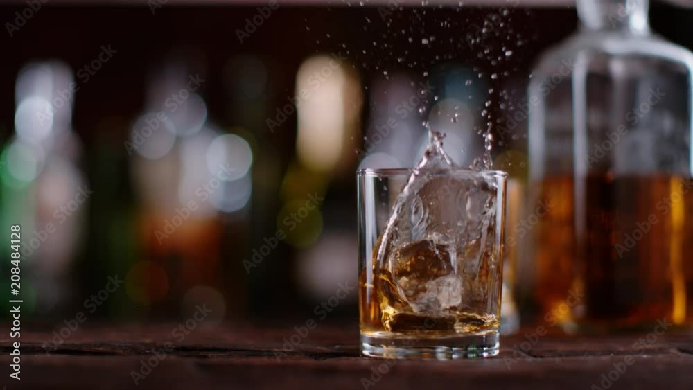 Super slow motion of pouring whiskey into glass. Filmed on cinema slow motion camera, 1000fps, ProRes 422 HQ codec. Super slow motion of pouring whiskey into glass. Filmed on cinema slow motion camera, 1000fps, ProRes 422 HQ codec.