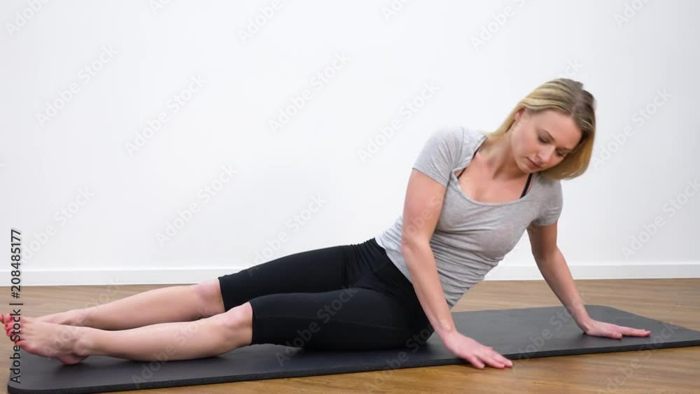 A young beautiful woman does yoga in a room A young beautiful woman does yoga in a room