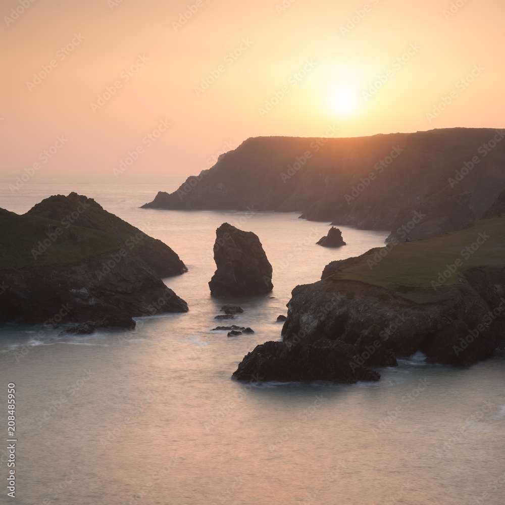 Stunning vibrant sunset landscape image of Kynance Cove on South Cornwall coast of England