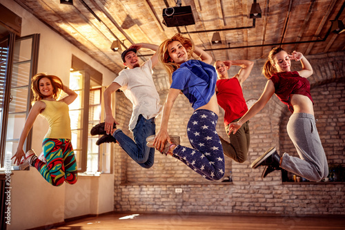 Fototapeta Naklejka Na Ścianę i Meble -  Dance team - happy dance friends jumping during music