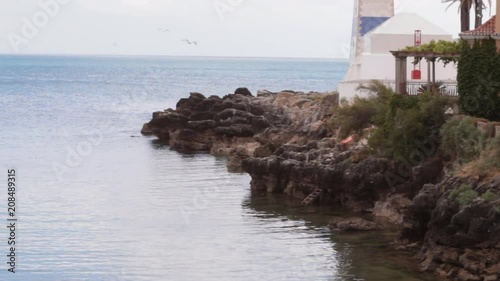 Mouth of the river on the sea with small rocks and crystal clear water and ladder