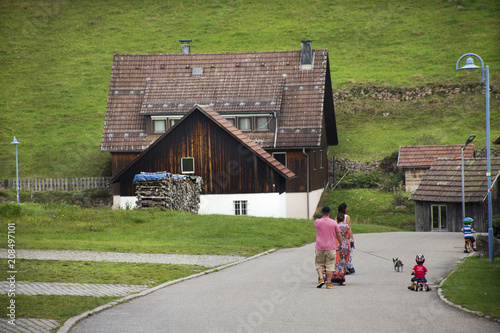 German family people travel and walking on street go to classic home at outdoor on mountain in forest at Enzklosterle city photo