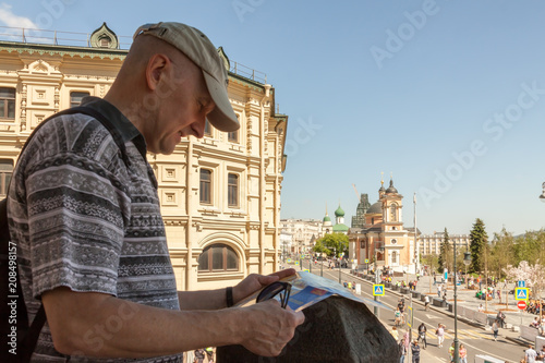 One tourist is looking at the Moscow city map on the street © svetlana