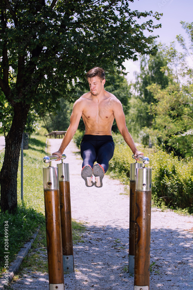 Fototapeta premium Young male fitness model exercise outdoor