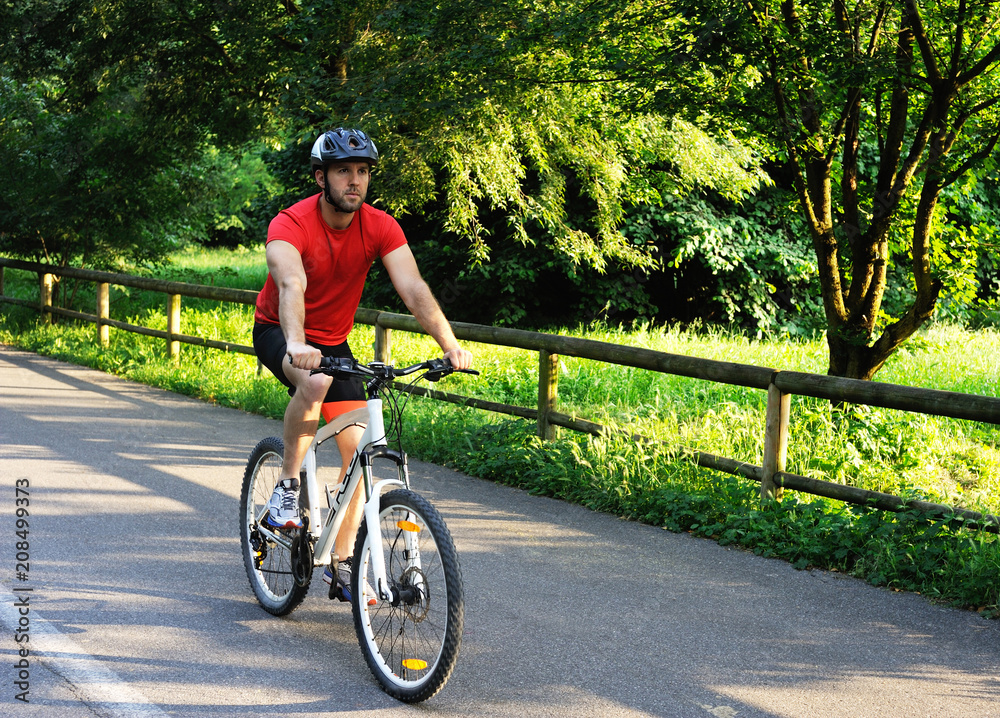 Fototapeta premium Cyclist riding a bike in the park