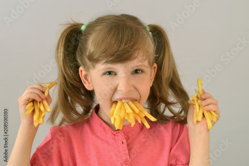 Child eats French fries
