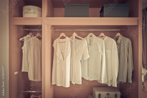 white color shirts hanging on rail