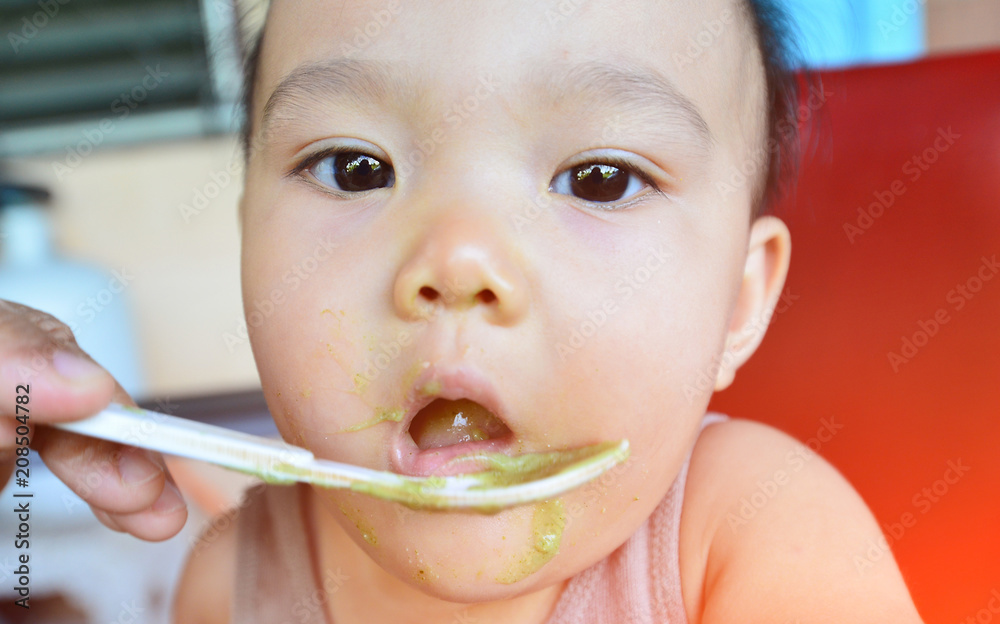 Face and gesture expression of Asian babies during eating time. Face and gesture expression of Asian babies during eating time.